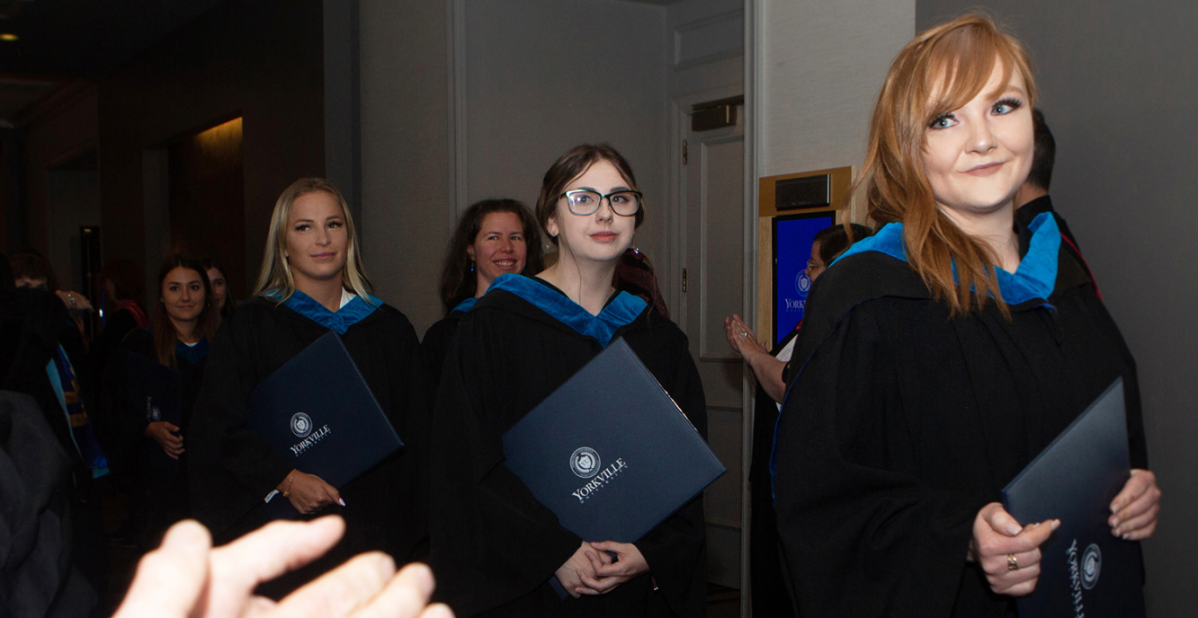 Graduates walking together with their diplomas