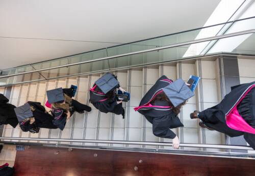 Graduates walking up stairs