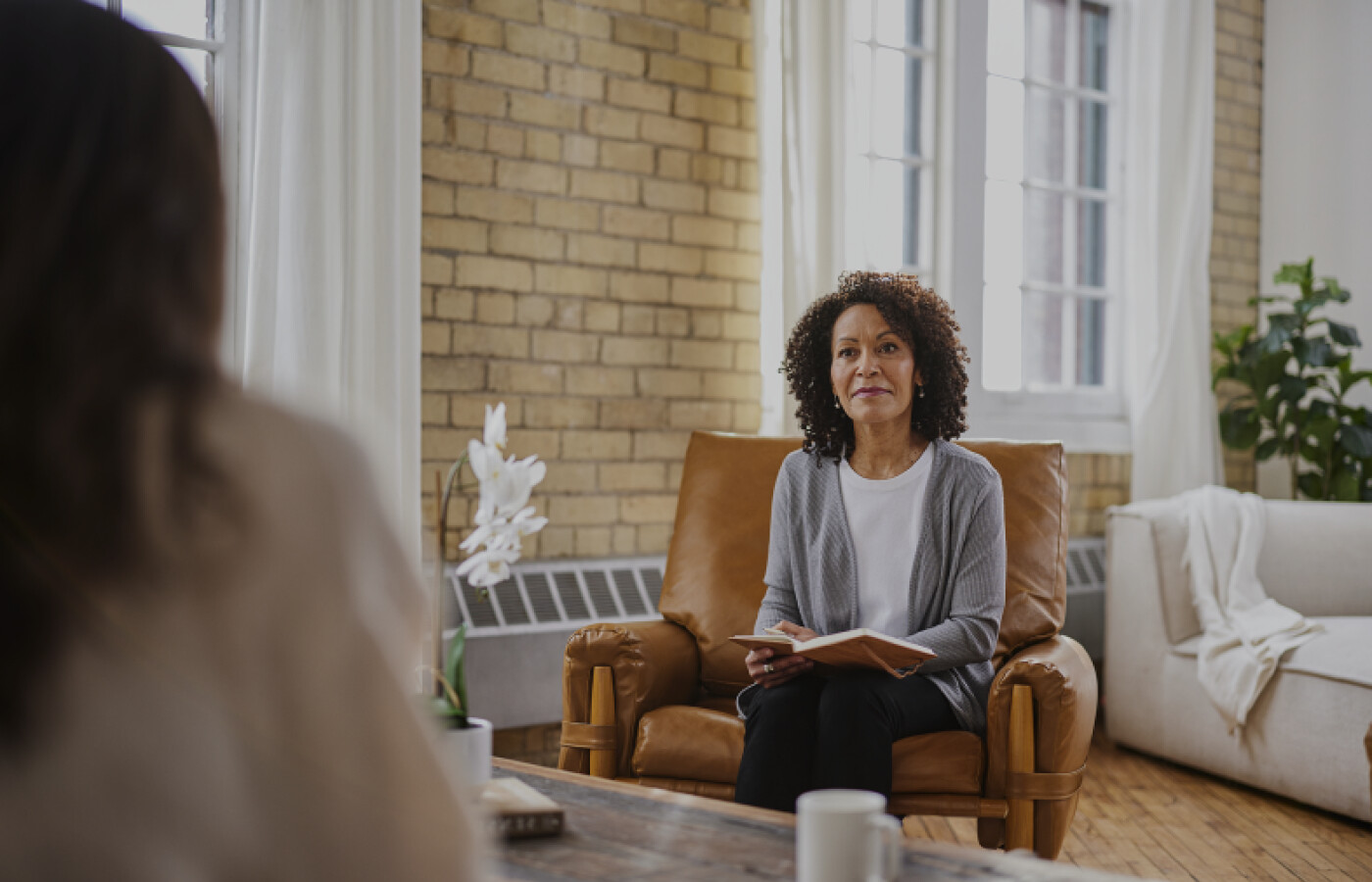 Woman with notebook sitting in counselling office