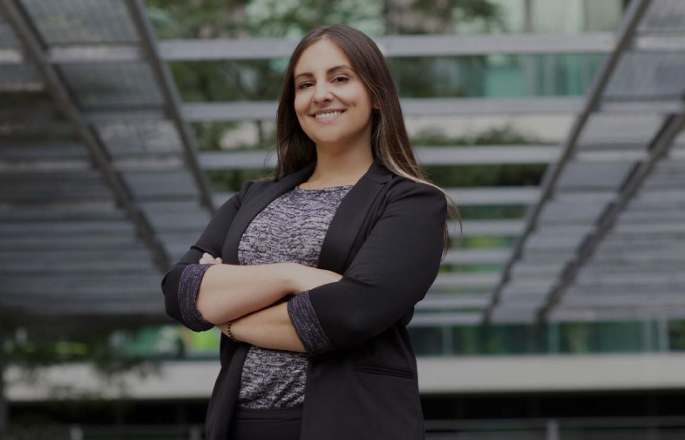 Woman standing with arms crossed smiling